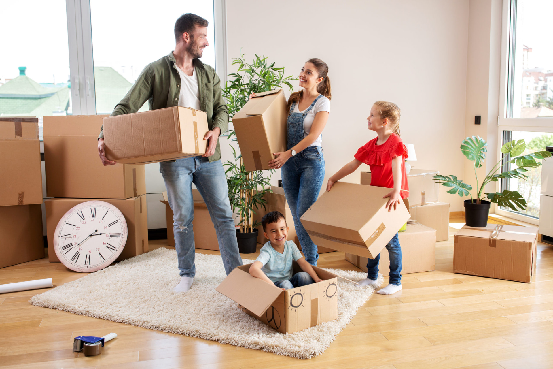 Family unpacking moving boxes in a relocation short let property under Renzo Airbnb & short let management in the UK