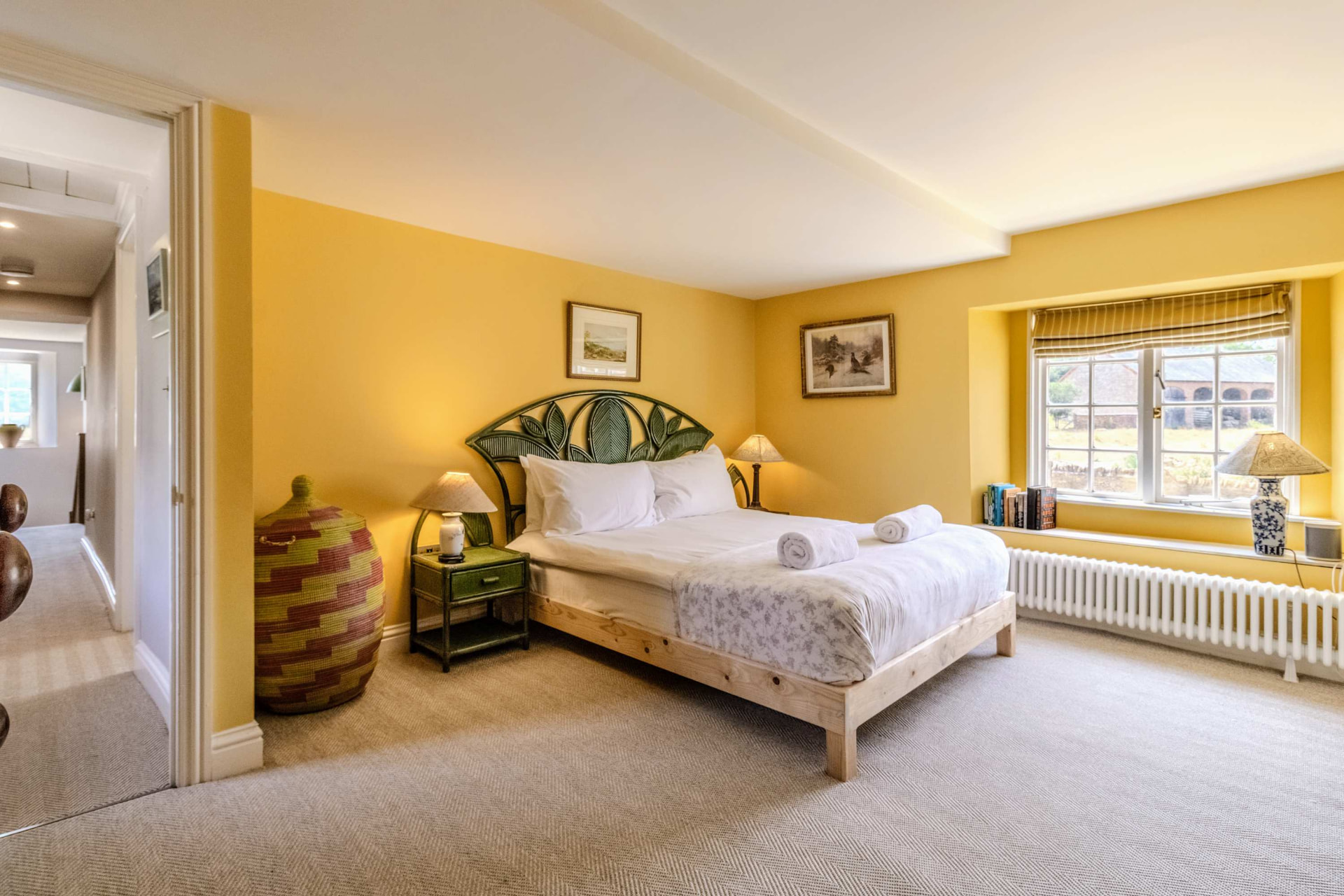 Bright, characterful short-let bedroom managed by Renzo, with crisp white linen and fresh towels